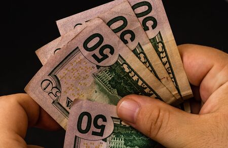 Man counting money, counting dollars close upの写真素材