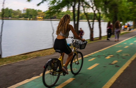 Girl riding a bicycle in King Mihai I park (Herastrau park) in Bucharest, Romania, 2019.