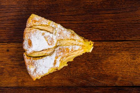 Freshly baked apple pie with sugar powder on a wooden board. Homemade apple cake.の写真素材