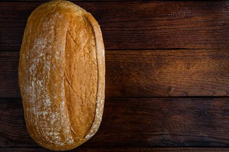 Freshly baked bread on a wooden board. Homemade bread.の写真素材
