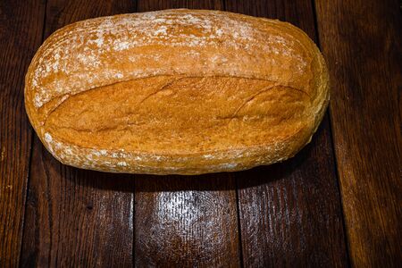 Freshly baked bread on a wooden board. Homemade bread.の写真素材