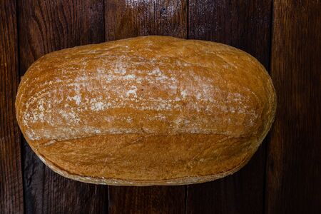 Freshly baked bread on a wooden board. Homemade bread.の写真素材
