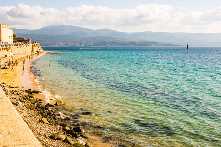 Ajaccio public beach with tourists at sunny day. Summer landscape of Corsica island at sunny summer...