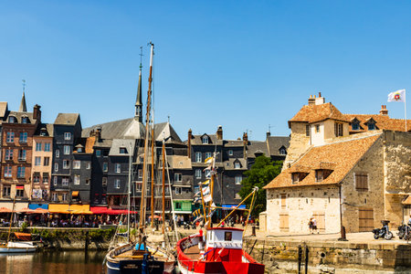 Honfleur harbor in Normandy, restaurant street with marina view in Honfleur, France, 2019のeditorial素材