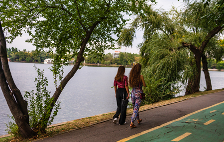 Young girls walking in King Mihai I park (Herastrau park) in Bucharest, Romania, 2019.のeditorial素材