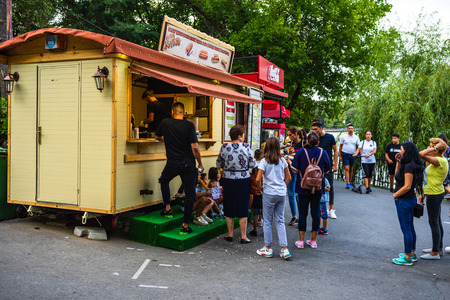 People buying goods from a shop in King Mihai I park (Herastrau park) in Bucharest, Romania, 2019.のeditorial素材