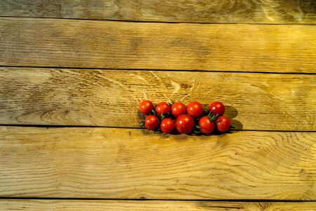 Fresh cherry tomatoes on a wooden board.の写真素材