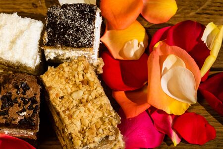 Diversity of mini cakes on a wooden board.の写真素材