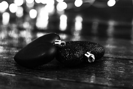 Black and white photo. Christmas decorations against blurred background. Christmas balls. Christmas lights.の写真素材