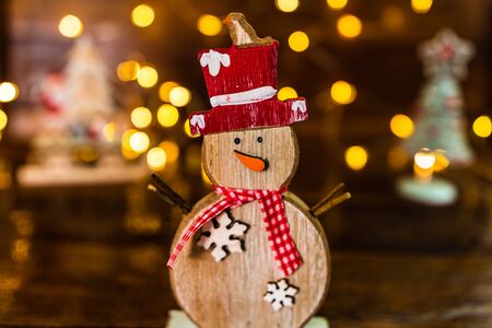 Christmas decorations against blurred background. Small wooden snowman.の写真素材