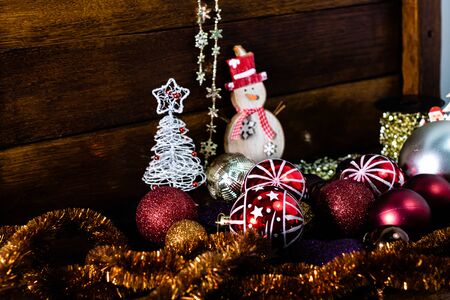 Christmas decorations on wooden board. Christmas concept. Colorful and glittery Christmas balls.の写真素材