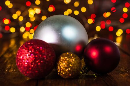 Christmas decorations against blurred background and out of focus lights. Close up of glittery Christmas ballsの写真素材