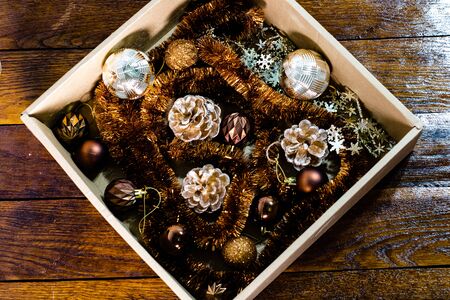 Christmas decorations in a box. Christmas concept. Christmas balls, pine cones, garlands.の写真素材