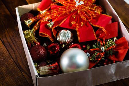 Christmas decorations in a box. Christmas concept. Box with Christmas balls on a wooden board.の写真素材