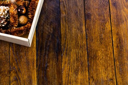 Christmas decorations in a box. Christmas concept. Box with Christmas balls on a wooden board.の写真素材
