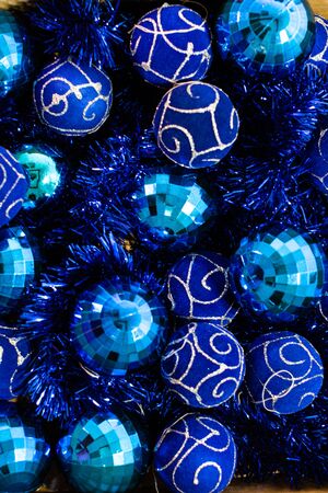 Christmas decorations in a box. Christmas concept. Box with blue Christmas balls and garlands.の写真素材