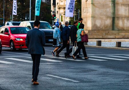 People, tourist crossing the street in downtown Bucharest, Romania, 2019のeditorial素材