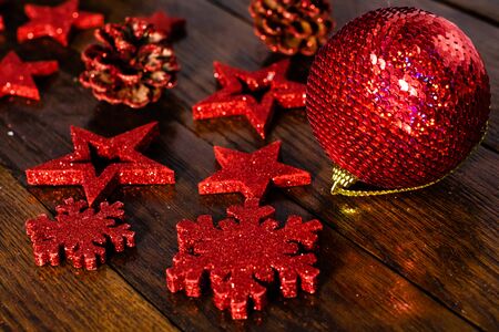 Christmas decorations on wooden board. Colorful, gliterry and shiny Christmas decorations.の写真素材