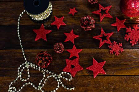 Christmas decorations on wooden board. Colorful, gliterry and shiny Christmas decorations.の写真素材