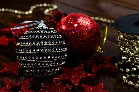 Christmas decorations on wooden board. Colorful, gliterry and shiny Christmas decorations.の写真素材