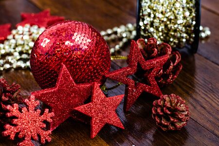Christmas decorations on wooden board. Colorful, gliterry and shiny Christmas decorations.の写真素材