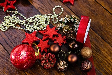 Christmas decorations on wooden board. Colorful, gliterry and shiny Christmas decorations.の写真素材