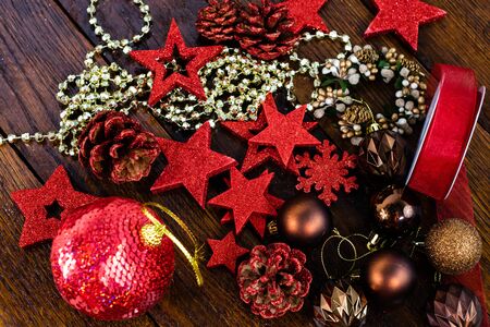 Christmas decorations on wooden board. Colorful, gliterry and shiny Christmas decorations.の写真素材