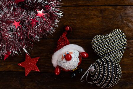 Christmas decorations on wooden board. Colorful, gliterry and shiny Christmas decorations.の写真素材