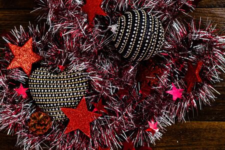 Christmas decorations on wooden board. Colorful, gliterry and shiny Christmas decorations.の写真素材
