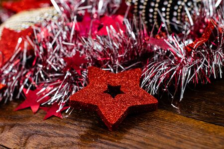 Christmas decorations on wooden board. Colorful, gliterry and shiny Christmas decorations.の写真素材