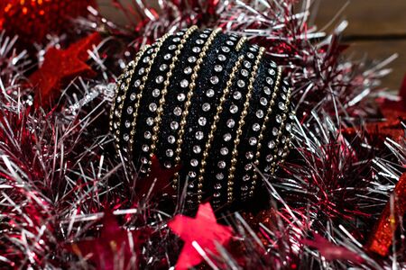 Christmas decorations on wooden board. Christmas concept. Black and shiny Christmas ball.の写真素材
