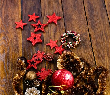 Christmas decorations on wooden board. Colorful, gliterry and shiny Christmas decorations.の写真素材