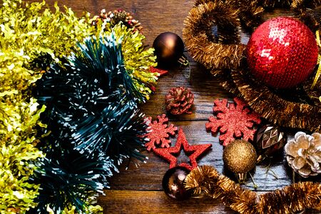 Christmas decorations on wooden board. Colorful, gliterry and shiny Christmas decorations.の写真素材