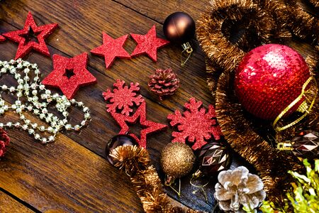 Christmas decorations on wooden board. Colorful, gliterry and shiny Christmas decorations.の写真素材