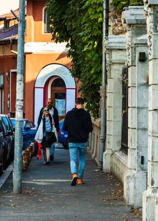 Young man walking on the sidewalk in Bucharest, Romania, 2019のeditorial素材