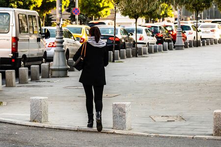 Woman using phone while walking in downtown Bucharest, Romania, 2019のeditorial素材