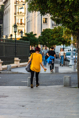 Young girl listening music while walking with a coffee cup in her hand in Bucharest, Romania, 2019のeditorial素材