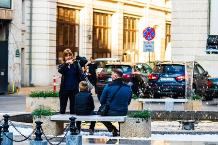 Tourists resting on a marble bench in downtown Bucharest, Romania, 2019のeditorial素材