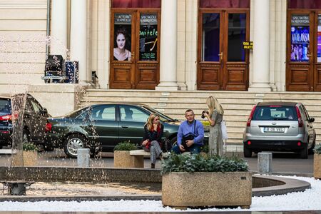 Tourists resting on a marble bench in downtown Bucharest, Romania, 2019のeditorial素材