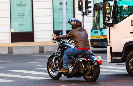 Man riding a motorbike on the streets of downtown Bucharest, Romania, 2019のeditorial素材