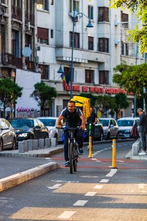 Glovo delivery service's deliveryman rides on a bicycle in Bucharest, Romania, 2019のeditorial素材