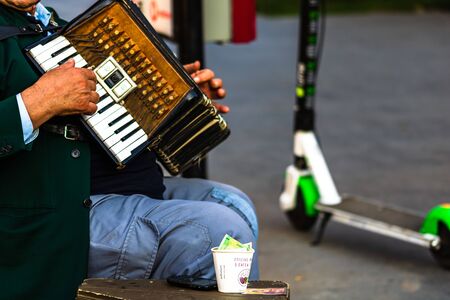 Local old man playing bandoneon (accordion) on the street in Bucharest, Romania, 2019のeditorial素材