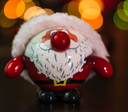 Christmas decoration and ornaments. Christmas composition on blurred lights background. Santa Claus Christmas ball.の写真素材