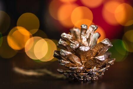 Christmas decoration and ornaments. Christmas composition on blurred lights background.Christmas pine cone.の写真素材