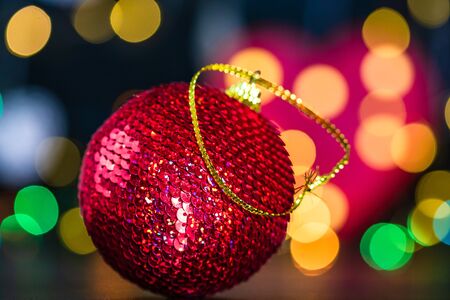 Christmas decoration and ornaments. Christmas composition on blurred lights background. Shiny Christmas ball.の写真素材