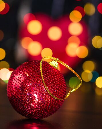 Christmas decoration and ornaments. Christmas composition on blurred lights background. Shiny Christmas ball.の写真素材