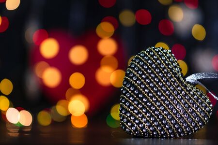 Christmas decoration and ornaments. Christmas composition on blurred lights background. Heart shaped Christmas ball.の写真素材