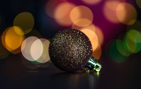 Christmas decoration and ornaments. Christmas composition on blurred lights background. Shiny Christmas ball.の写真素材
