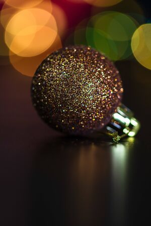Christmas decoration and ornaments. Christmas composition on blurred lights background. Shiny Christmas ball.の写真素材