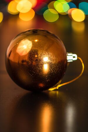 Christmas decoration and ornaments. Christmas composition on blurred lights background. Shiny Christmas ball.の写真素材
